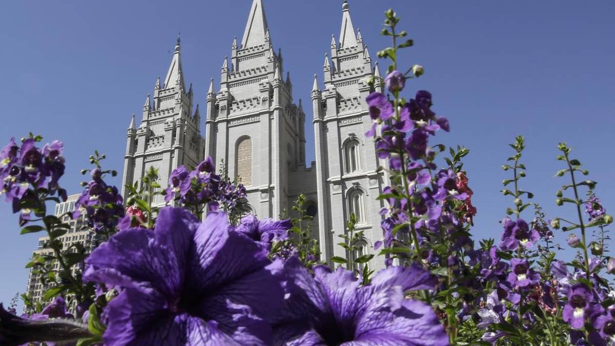FILE- In this Sept. 3, 2014, file photo, shows flowers blooming in front of the Salt Lake Temple. in Temple Square, in Salt Lake City. Mormon church leaders are making a national appeal for a "balanced approach" in the clash between gay rights and religious freedom. The church is promising to support some housing and job protections for gays and lesbians in exchange for legal protections for believers who object to the behavior of others. (AP Photo/Rick Bowmer, File)