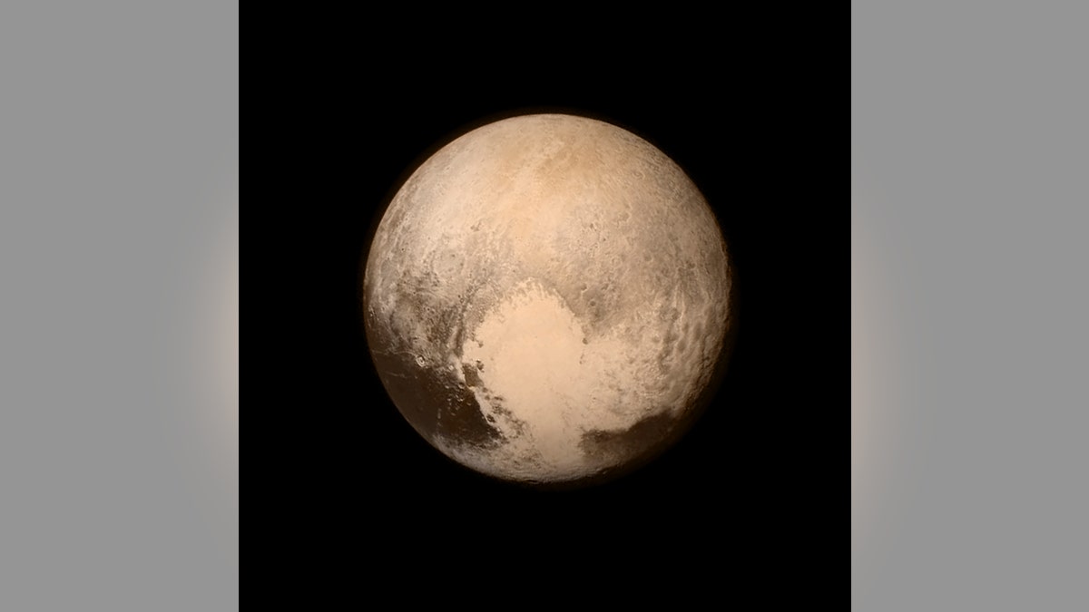 IN SPACE - JULY 14:  In this handout provided by the National Aeronautics and Space Administration (NASA), Pluto nearly fills the frame in this image from the Long Range Reconnaissance Imager (LORRI) aboard NASA's New Horizons spacecraft, taken on July 13, 2015, when the spacecraft was 476,000 miles (768,000 kilometers) from the surface. This is the last and most detailed image sent to Earth before the spacecraft's closest approach to Pluto. New Horizons spacecraft is nearing its July 14 fly-by when it will close to a distance of about 7,800 miles (12,500 kilometers). The 1,050-pound piano sized probe, which was launched January 19, 2006 aboard an Atlas V rocket from Cape Canaveral, Florida, is traveling 30,800 mph as it approaches.  (Photo by NASA/APL/SwRI via Getty Images)