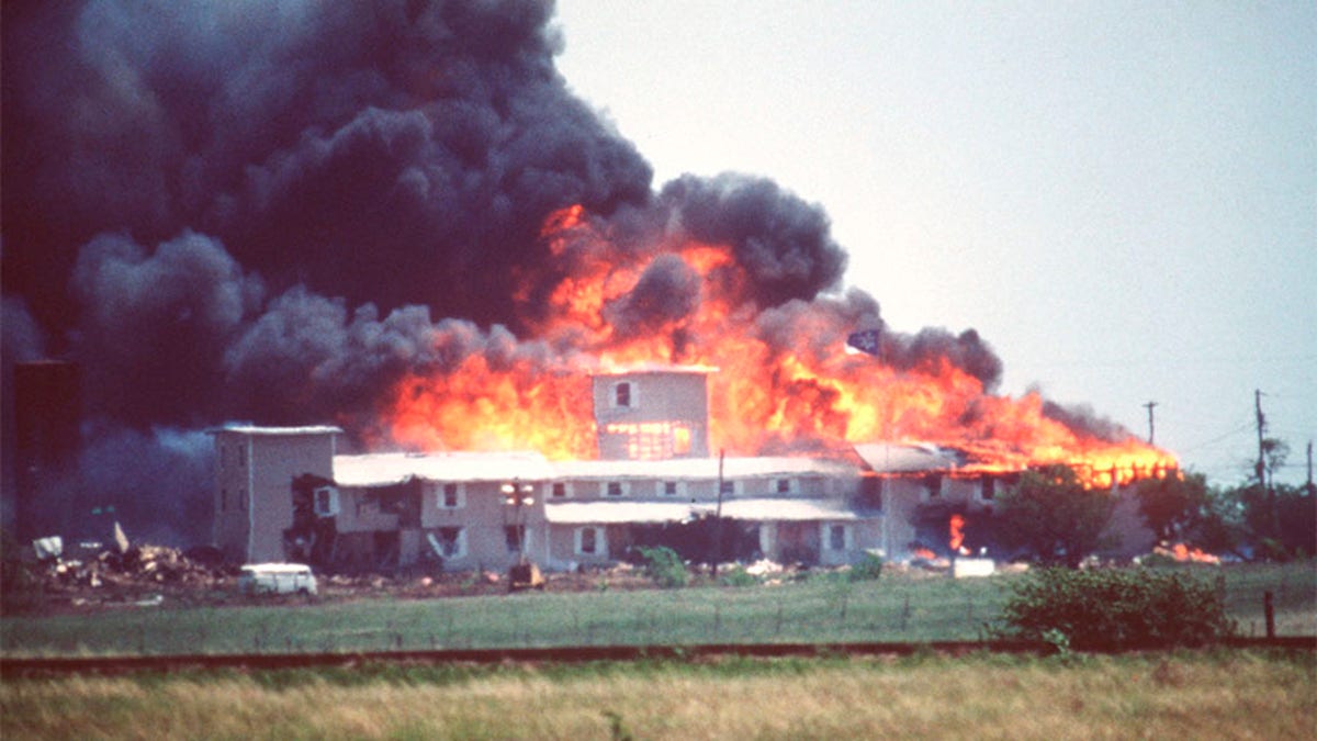 Smoking fire consumes the Branch Davidian Compound during the FBI assault to end the 51-day standoff with cult leader David Koresh and his followers. --- Photo by Greg Smith/Corbis SABA (Photo by Greg Smith/Corbis via Getty Images)