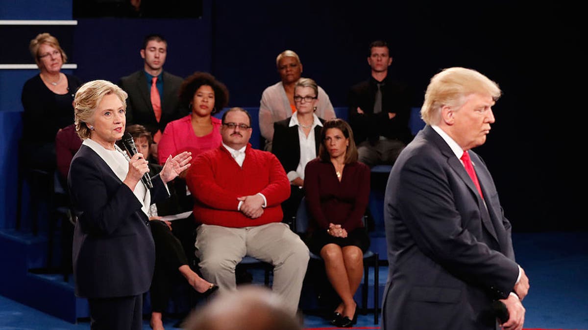 Hillary Clinton (left) and Donald Trump (right) share their positions while Ken Bone (center) listens at the town hall debate on Saturday (Oct. 9).