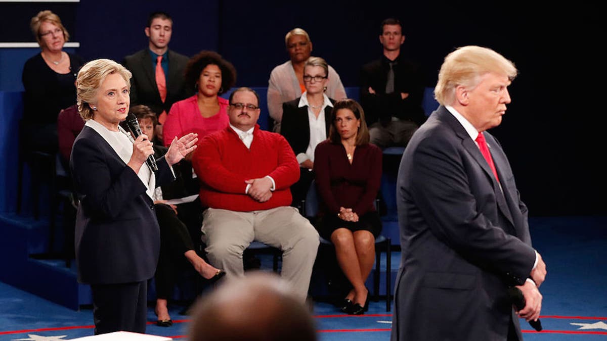 Hillary Clinton (left) and Donald Trump (right) share their positions while Ken Bone (center) listens at the town hall debate on Saturday (Oct. 9).