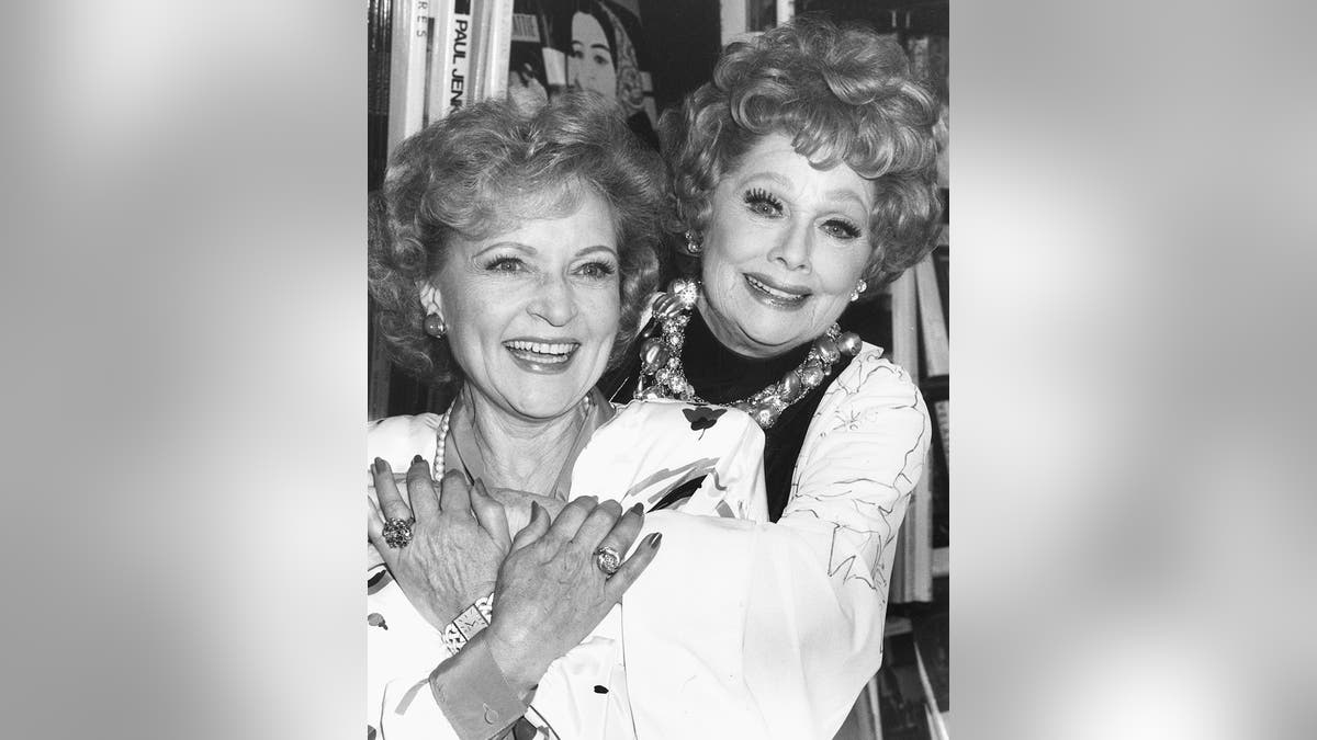 Actresses Betty White (left) and Lucille Ball embracing at a book signing event in Los Angeles, October 2nd 1987. (Photo by Kevin Winter/Getty Images)