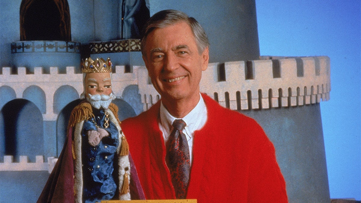 Portrait of children's television personality Fred Rogers (1928 - 2003) smiling while posing with a toy trolley on the set of his television show 'Mister Rogers' Neighborhood,' circa 1980s.  (Photo by Fotos International/Courtesy of Getty Images)