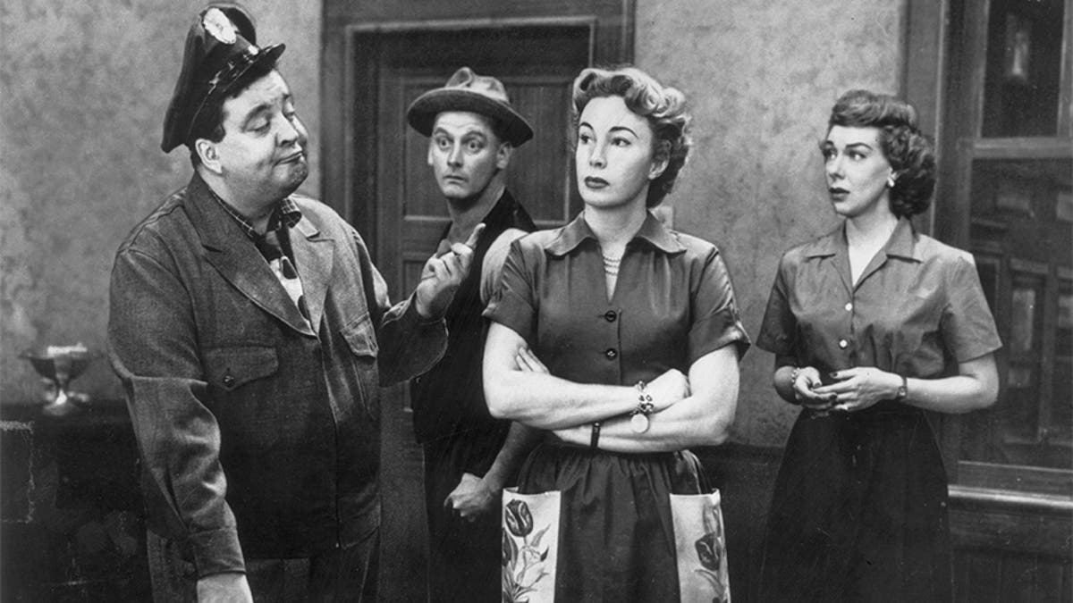 Left to right: American actors Jackie Gleason (1916 - 1987), Art Carney (1918 - 2003), Audrey Meadows (1922 - 1996) and Joyce Randolph gather around a table in a still from the television series, 'The Honemooners,' circa 1955. (Photo by CBS Photo Archive/Getty Images) 