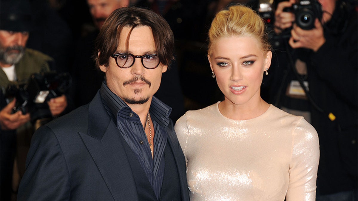 LONDON, UNITED KINGDOM - NOVEMBER 03: Johnny Depp and Amber Heard attend The UK Premiere of 'The Rum Diary' at on November 3, 2011 in London, England. (Photo by Stuart Wilson/Getty Images)