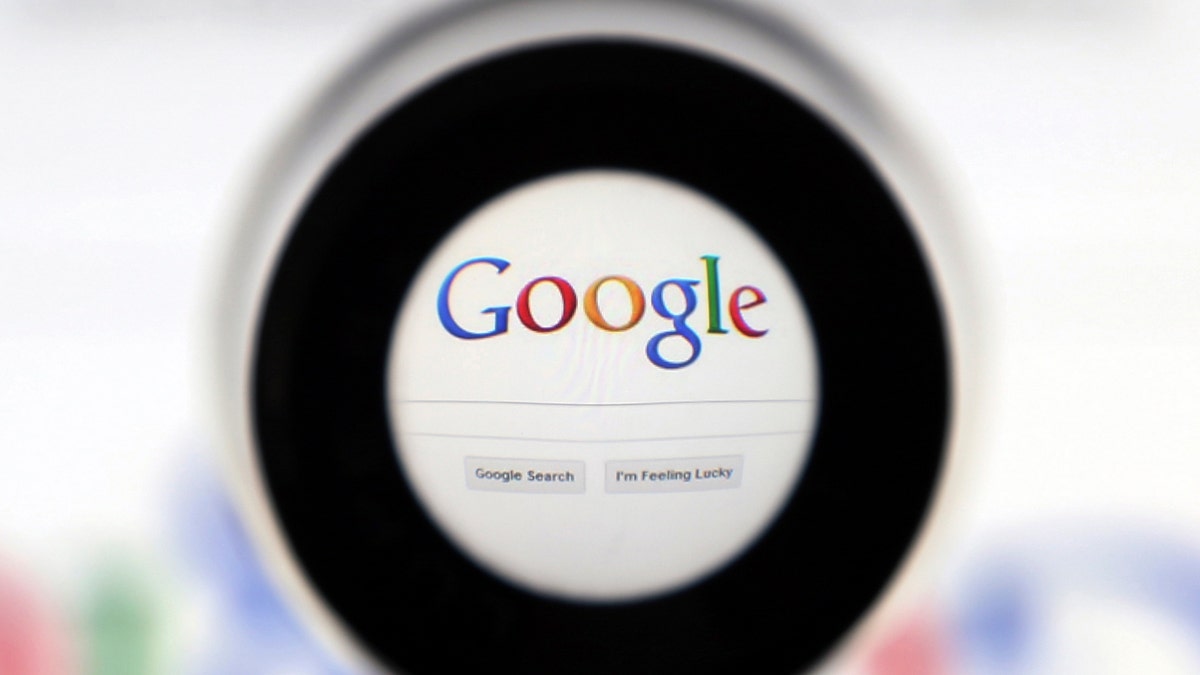 A Google search page is seen through a magnifying glass in this photo illustration taken in Brussels May 30, 2014. 