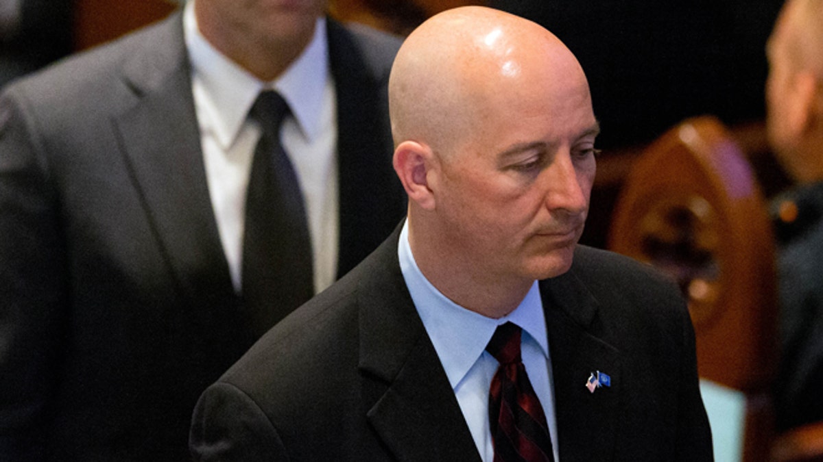 Nebraska Gov. Pete Ricketts at the funeral service for Omaha police detective Kerrie Orozco Tuesday, May 26, 2015 at St. John's Catholic Church at Creighton University in Omaha, Neb. (Matt Miller/The World-Herald via AP, Pool)