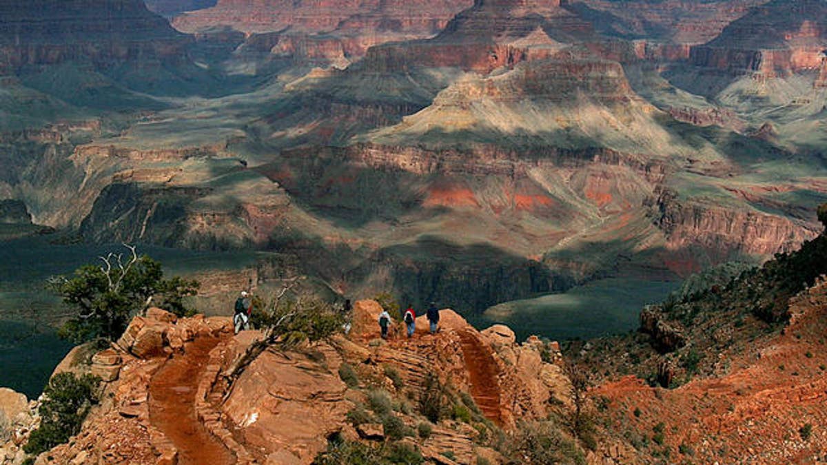 With the North Rim in the background, tourists hike along the South Rim of the Grand Canyon Tuesday, Feb. 22, 2005.