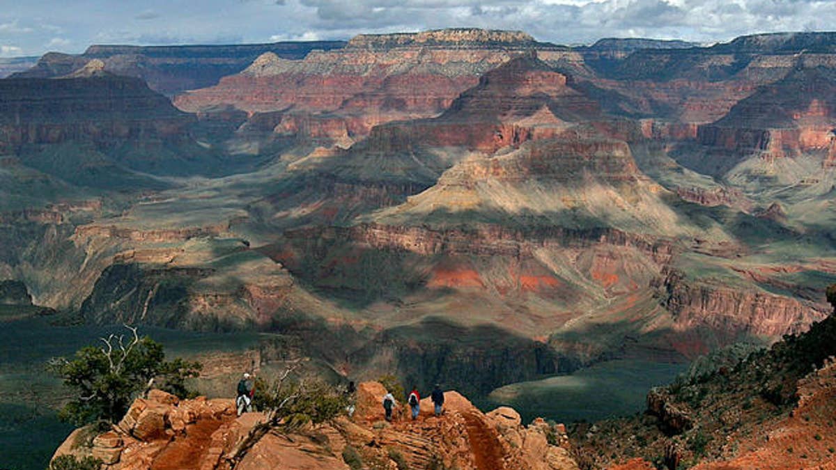 With the North Rim in the background, tourists hike along the South Rim of the Grand Canyon Tuesday, Feb. 22, 2005.