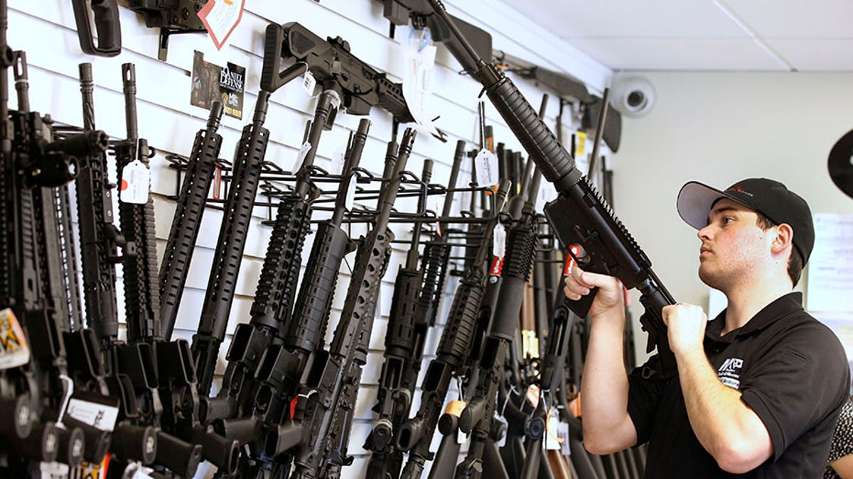 Salesman Ryan Martinez clears the chamber of an AR-15 at the "Ready Gunner" gun store In Provo, Utah, U.S. in Provo, Utah, U.S., June 21, 2016. REUTERS/George Frey - S1AETLGJCGAB