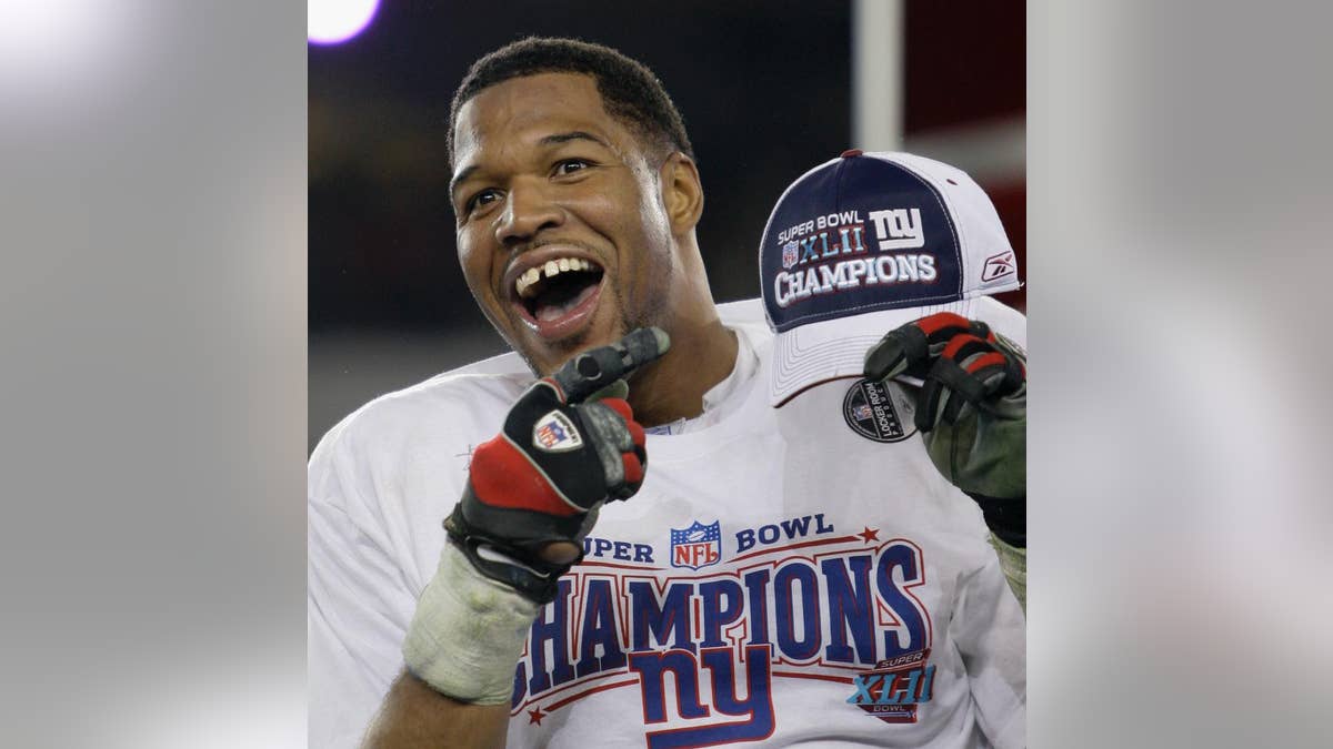 FILE - In this Feb. 3, 2008, file photo, New York Giants defensive end Michael Strahan celebrates after the Giants defeated the New England Patriots 17-14 in the Super Bowl XLII football game in Glendale, Ariz. While Strahan was a game-changer on the field, he was making his mark elsewhere with his gregarious personality, gap-toothed smile and willingness to step out of his comfort zone. He became a regular in commercials,  (AP Photo/David J. Phillip, File)