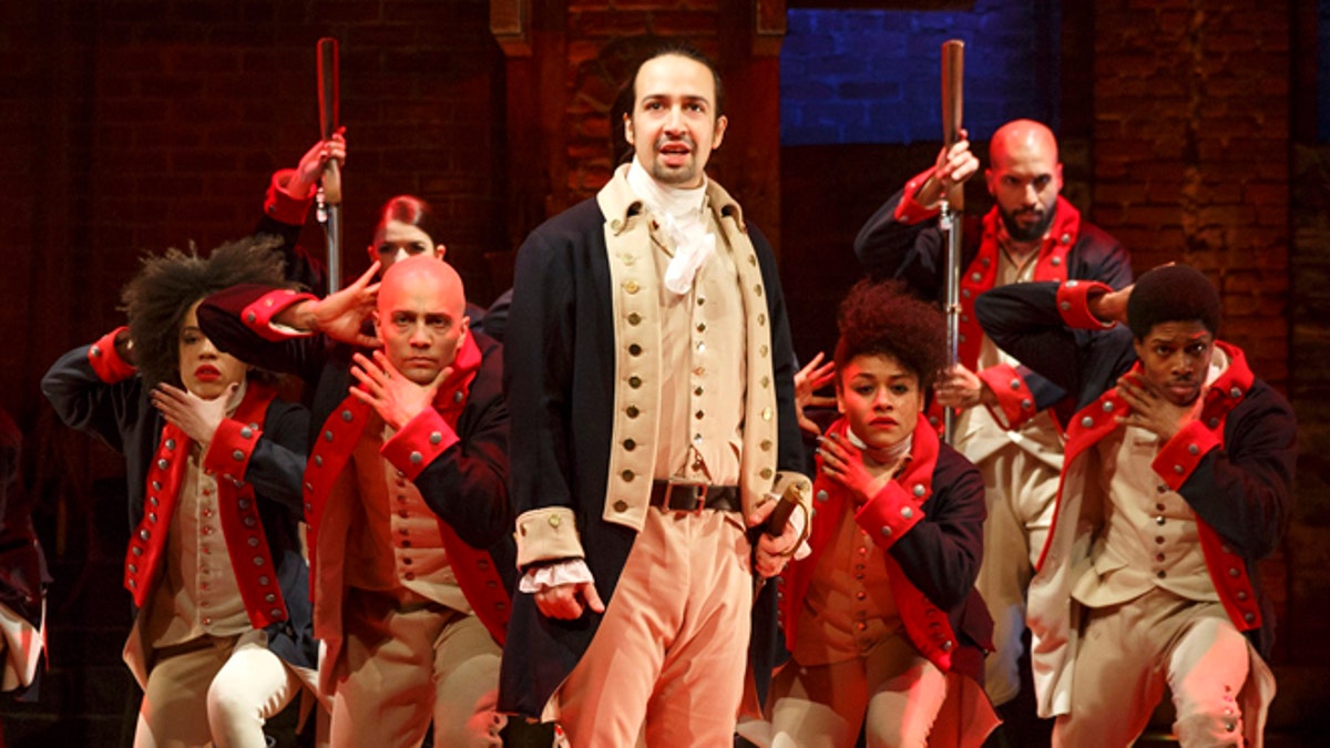 This image released by The Public Theater shows Lin-Manuel Miranda, foreground, with the cast during a performance of 