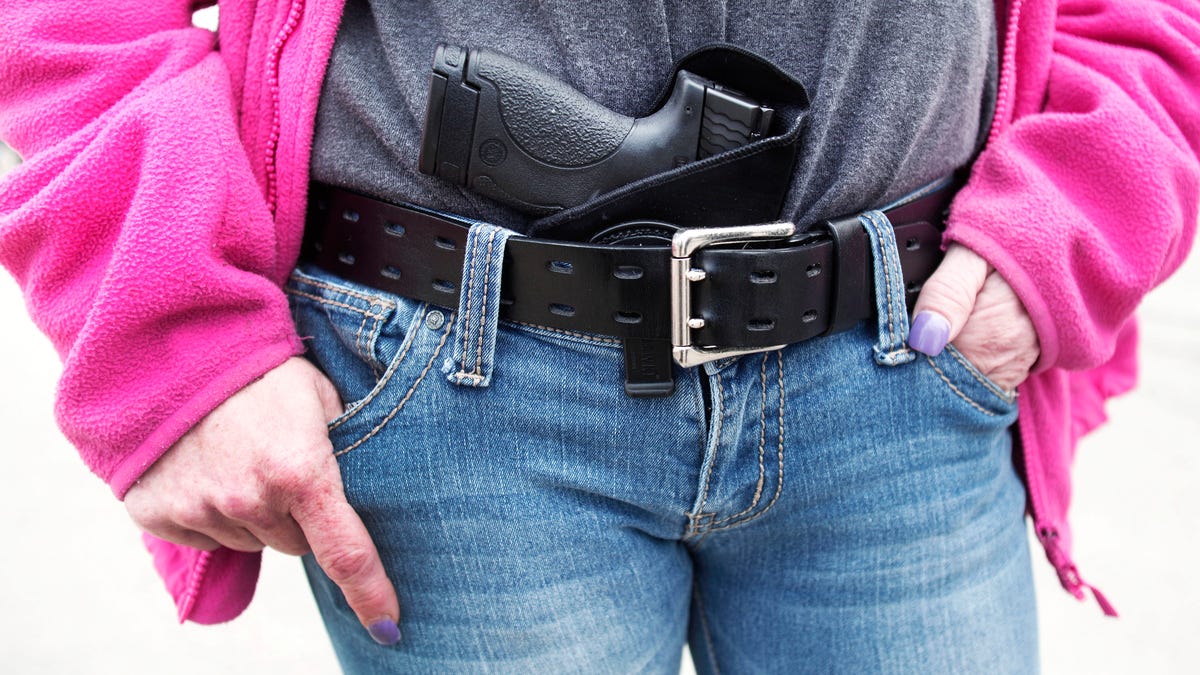 ROMULUS, MI - APRIL 27: Gloria Lincoln-Thompson of Garden City, Michigan carries her Smith & Wesson Shield 9mm pistol in her belt while participating in a rally and march supporting Michigan's Open Carry law April 27, 2014 in Romulus, Michigan. The march was held to attempt to demonstrate to the general public what the typical open carrier is like. (Photo by Bill Pugliano/Getty Images)