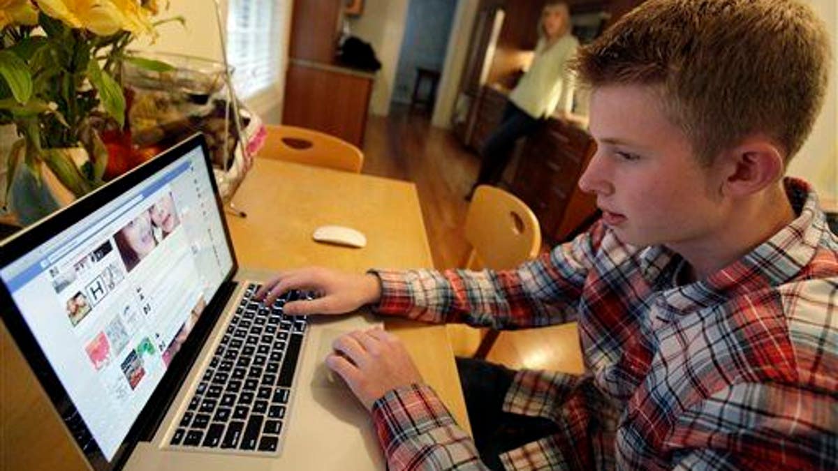 In this photo, Mark Risinger, 16, checks his Facebook page in Glenview, Ill.