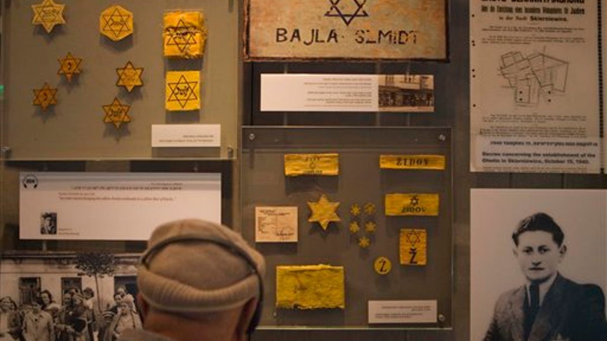 A visitor looks at the display at the Yad Vashem Holocaust memorial in Jerusalem on the international Holocaust remembrance day Wednesday, Jan. 27, 2010. The International Holocaust remembrance day marks the liberation of the Auschwitz concentration camp on Jan. 27, 1945.(AP Photo/Dan Balilty)