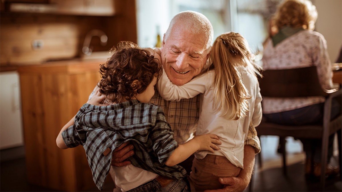 Close up of a grandfather playing with his grandkids