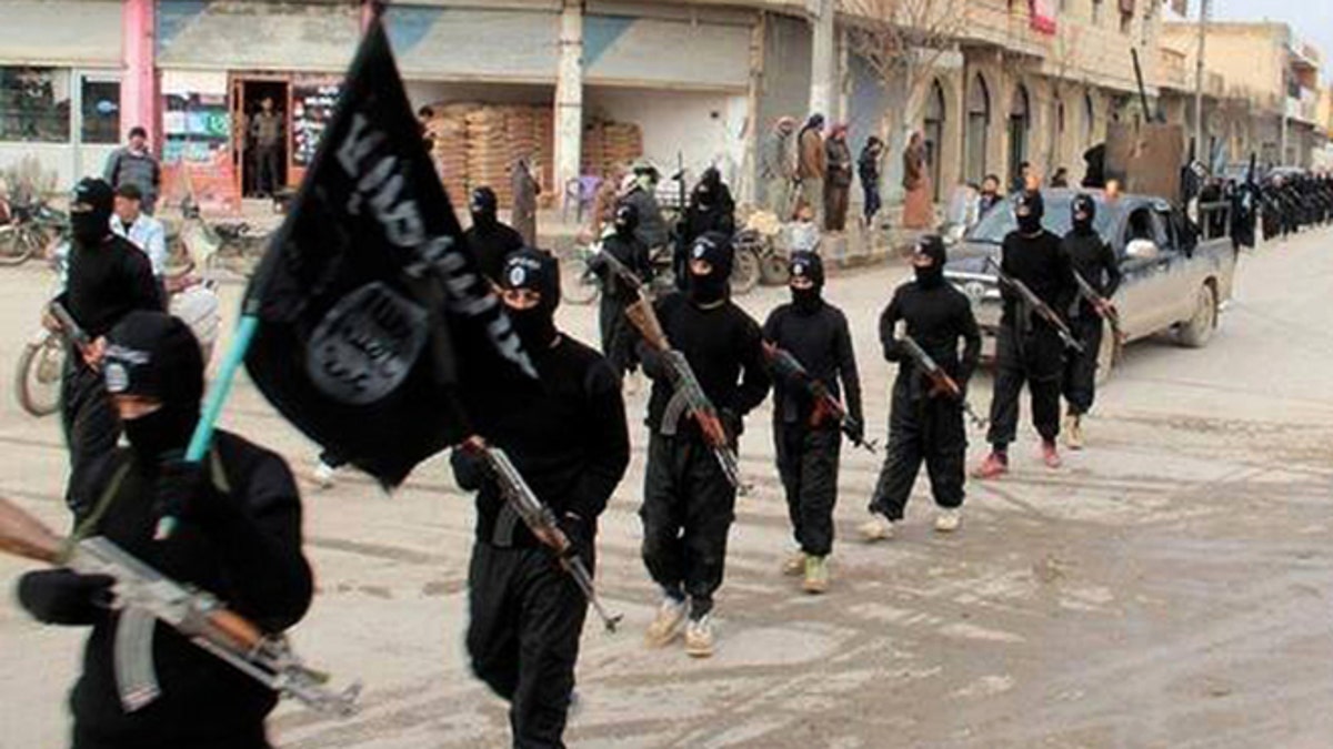 Jan. 14, 2014: Fighters from ISIS marching in Raqqa, Syria. 