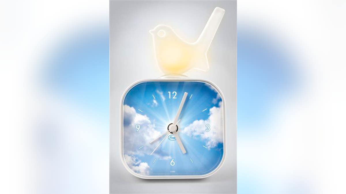 A clock with clouds in background