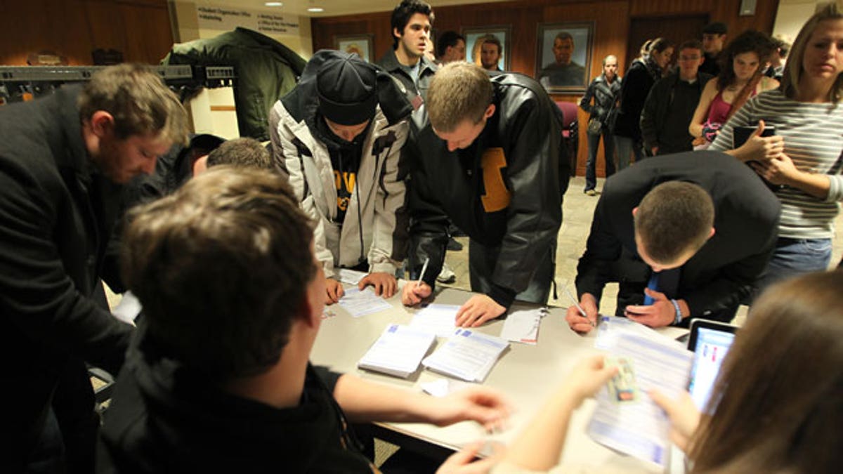 Caucus voters filling out same-day voter registration paperwork to participate in the 2012 Republican presidential caucus in Iowa