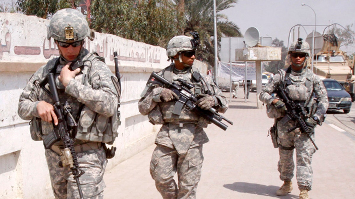 March 23, 2011: U.S. troops stand guard outside a local journalists' union office in Basra, Iraq.