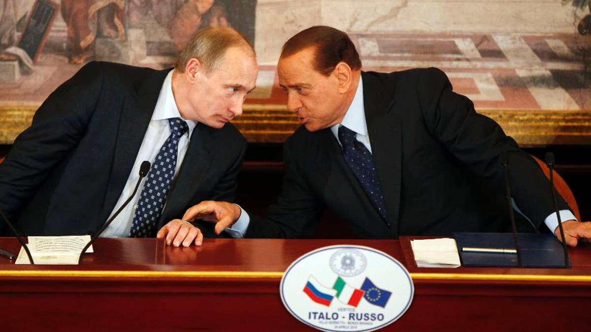 FILE -- In this April 26, 2010 file photo, then Italian Premier Silvio Berlusconi, right, and Russian President Vladimir Putin talk during a press conference at Villa Gernetto, in Gerno, near Milan, Italy. The Kremlin is denying that President Vladimir Putin offered to make Silvio Berlusconi his economy minister, though he did extend "metaphorical support" to Italy's embattled ex-premier. (AP Photo/Luca Bruno, File)