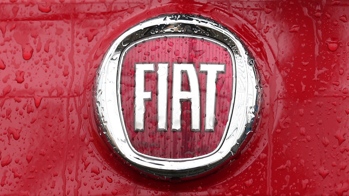 Rain falls on a Fiat logo pictured on a car in Milan, Italy, Thursday, Jan. 2, 2014. Italian automaker Fiat SpA announced that it reached an agreement to acquire the remaining shares of Chrysler for $3.65 billion in payments to a union-controlled trust fund. Fiat already owns 58.5 percent of Chrysler's shares, with the remaining 41.5 percent held by a United Auto Workers union trust fund that pays health care bills for retirees.( AP Photo/Antonio Calanni)