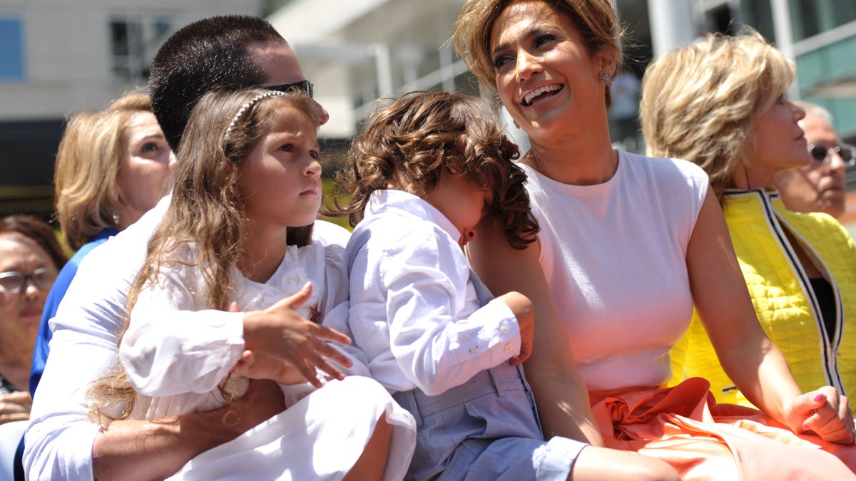 Actress and singer Jennifer Lopez, right, appears with her twins Emme Marbiel Muniz, left, and Maximilian David Muniz, on the lap of Casper Smart at a ceremony honoring her on the Hollywood Walk of Fame on Thursday, June 20, 2013 in Los Angeles. (Photo by John Shearer/Invision/AP)