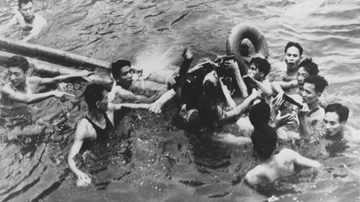 FILE PHOTO 26OCT67 - John McCain is pulled out of a Hanoi lake by a mix of North Vietnamese Army (NVA) and Vietnamese citizens in this October, 1967 file photo. McCain, currently a Republican presidential candidate, was shot down by a Surface-to-Air Missile (SAM) and had broken both arms and his right knee upon ejection, losing consciousness until he hit the water.

HB/ - RP2DRHYBNYAB