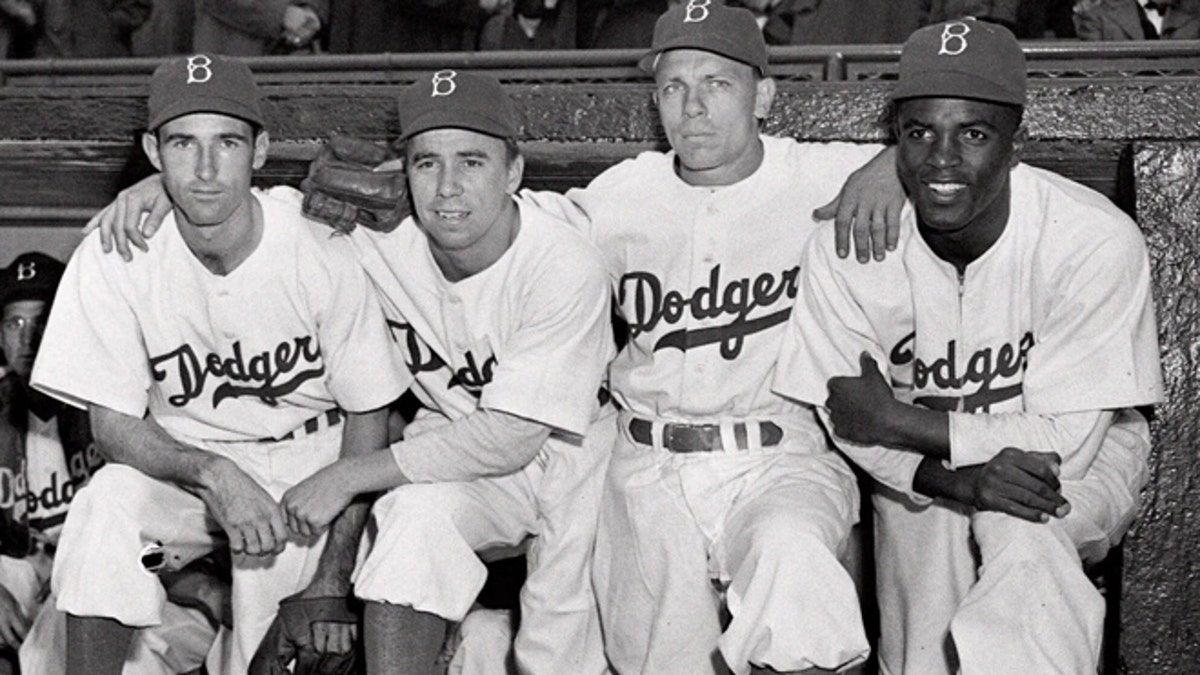FILE: From left, Brooklyn Dodgers baseball players John Jorgensen, Pee Wee Reese, Ed Stanky and Jackie Robinson pose at Ebbets Field in New York on April 15, 1947.