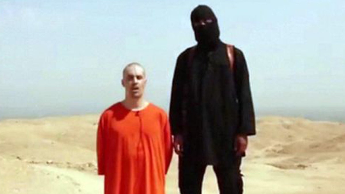 This still from a video released last August by ISIS shows American James Foley with a man believed to be Mohammed Emwazi, formerly known by the alias, 