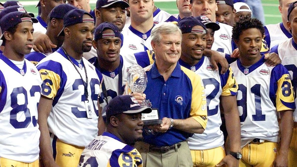 ATLANTA, UNITED STATES: St. Louis Rams head coach Dick Vermeil (C) stands with his team holding the 1999 Staples NFL Coach of the Year award giving to Vermeil before media day 25 January, 2000 at the Georgia Dome the site of Super Bowl XXXIV in Atlanta. The Rams will take on the Tennessee Titans in the Super Bowl on 30 January, 2000. (ELECTRONIC IMAGE) AFP PHOTO/JEFF HAYNES (Photo credit should read JEFF HAYNES/AFP/Getty Images)