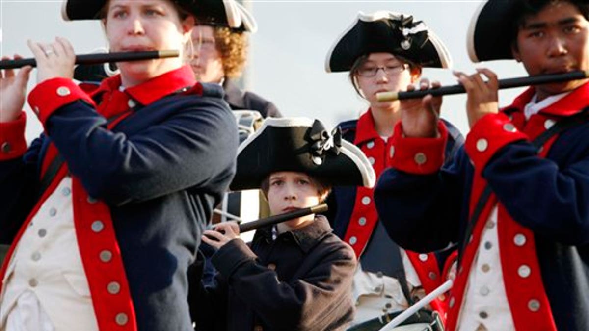 Members of the William Diamond Junior Fife and Drum Corp from Lexington, Mass., perform on the site of the USS Constitution as part of Independence Day weekend events in Boston, Friday, July 1, 2011. (AP Photo/Michael Dwyer)