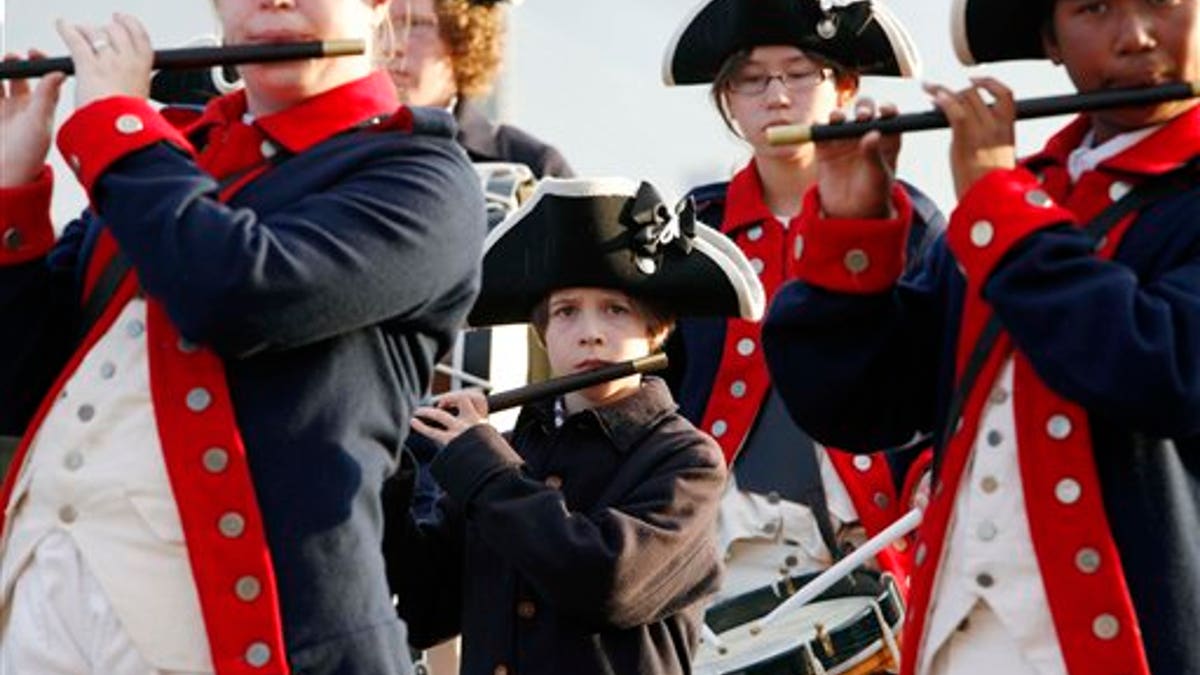 Members of the William Diamond Junior Fife and Drum Corp from Lexington, Mass., perform on the site of the USS Constitution as part of Independence Day weekend events in Boston, Friday, July 1, 2011. (AP Photo/Michael Dwyer)