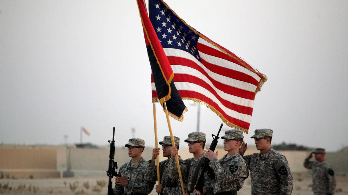 U.S. Army soldiers take part in the casing ceremony on Aug. 21 for the last American combat brigade to serve in Iraq as a small army of American diplomats is left behind to keeping the volatile country from slipping back to the brink of civil war.(AP)