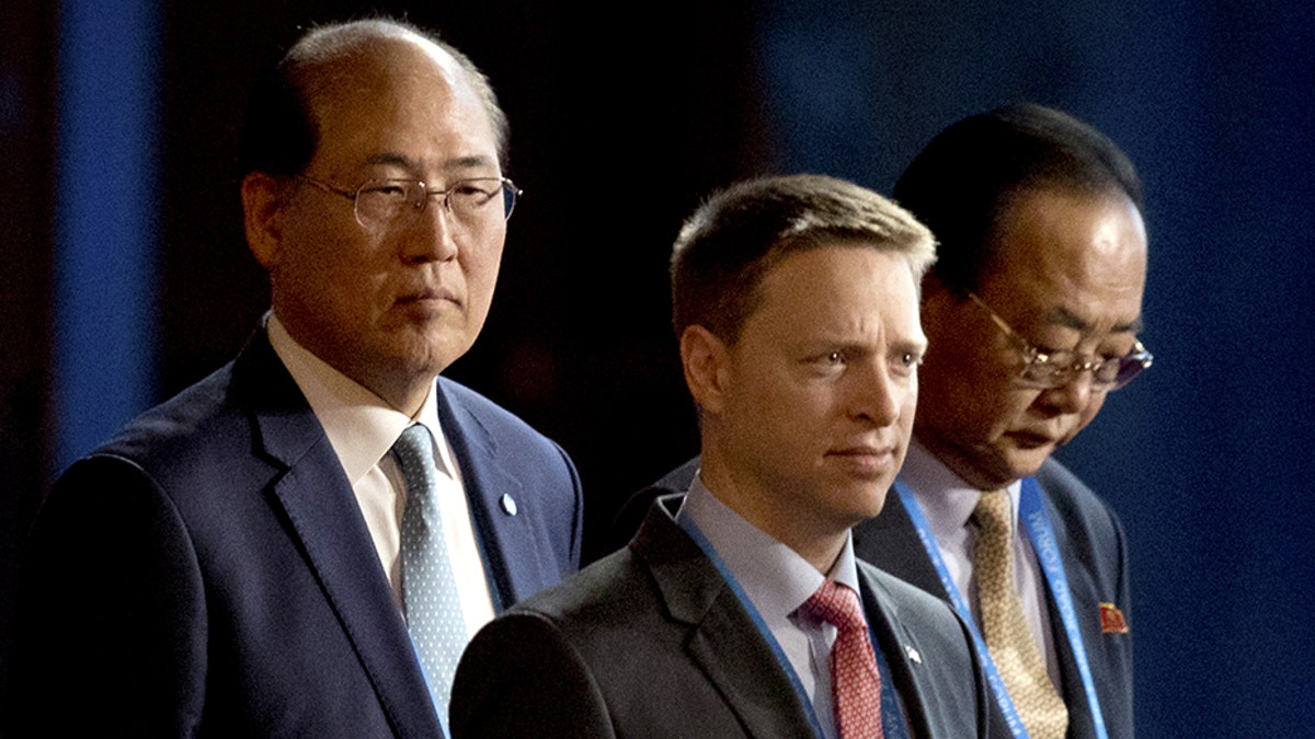 Matt Pottinger, the National Security Council's senior director for Asia, center, is in Singapore.