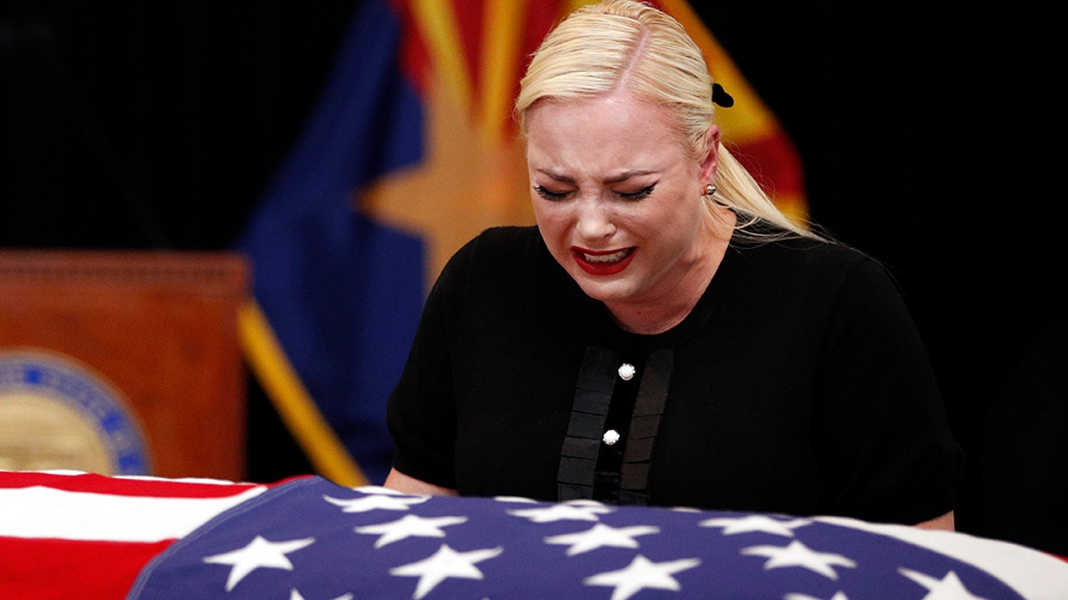 Meghan McCain, daughter of, Sen. John McCain, R-Ariz. cries at the casket of her father