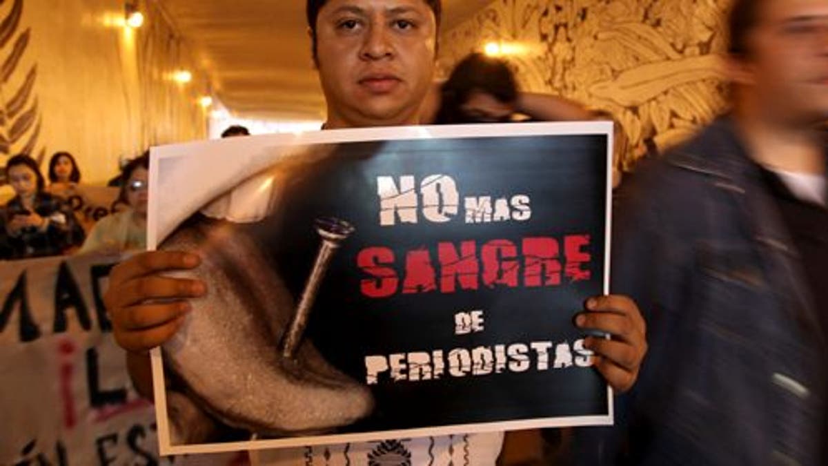 A man carrying a sign saying "No more blood of journalists" during a protest to demand justice in the Regina Martinez case, a journalist killed a year ago, and an end to more recent attacks on the press in Veracruz, Mexico, Sunday April 28, 2013. Journalists in several states organized a demonstration on Sunday to mark the first anniversary of the murder of Regina Martinez, a correspondent of the magazine Proceso. Attacks have become so common that many Mexican news media have announced they will no longer cover stories related to drug cartels.The issue has become so serious that Mexico's congress passed a bill this month that would allow journalists to request that federal prosecutors and federal judges investigate attacks on them, and would make federal intervention mandatory in some cases. It has been sent to the president for his signature.(AP Photo/Felix Marquez)