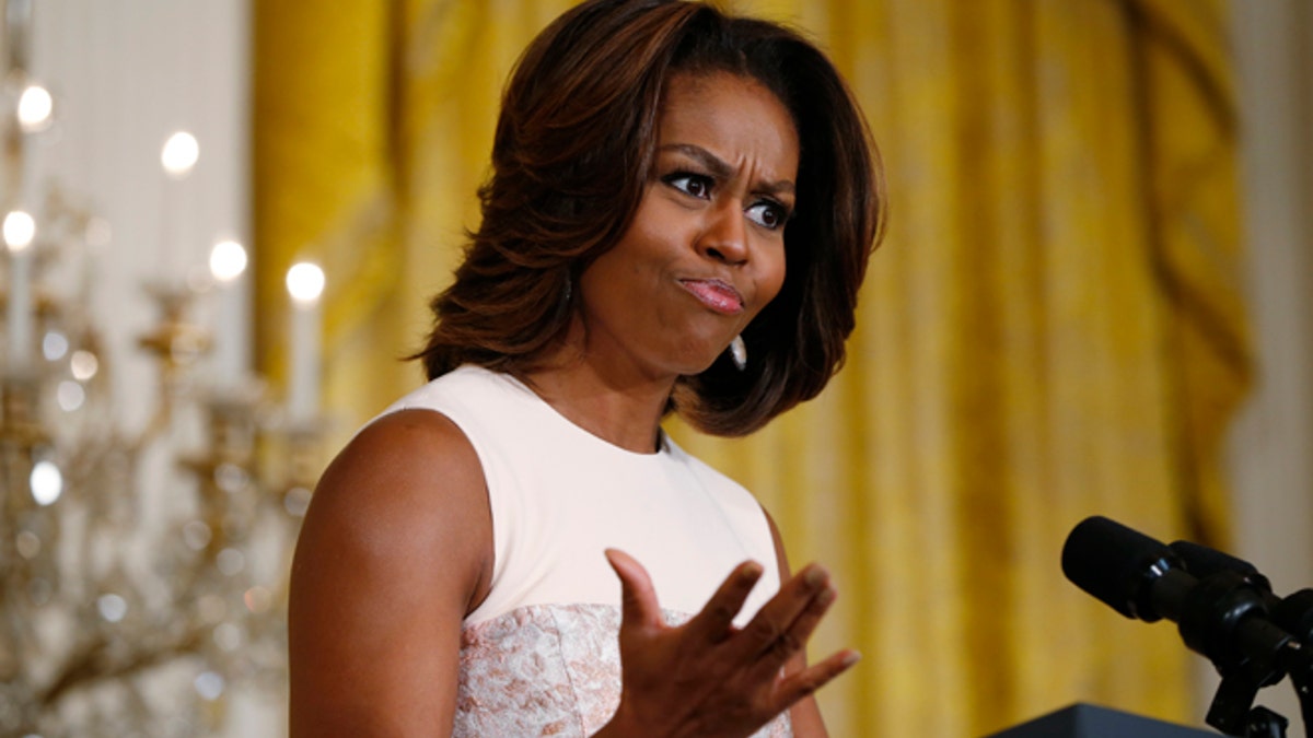First lady Michelle Obama recites a "wrap" song written by students from George C. Marshall High School in Falls Church, Va., about healthy eating as she announced proposed guidelines for local school wellness policies during an event in the East Room at the White House in Washington, Tuesday, Feb. 25, 2014. (AP Photo/Charles Dharapak)