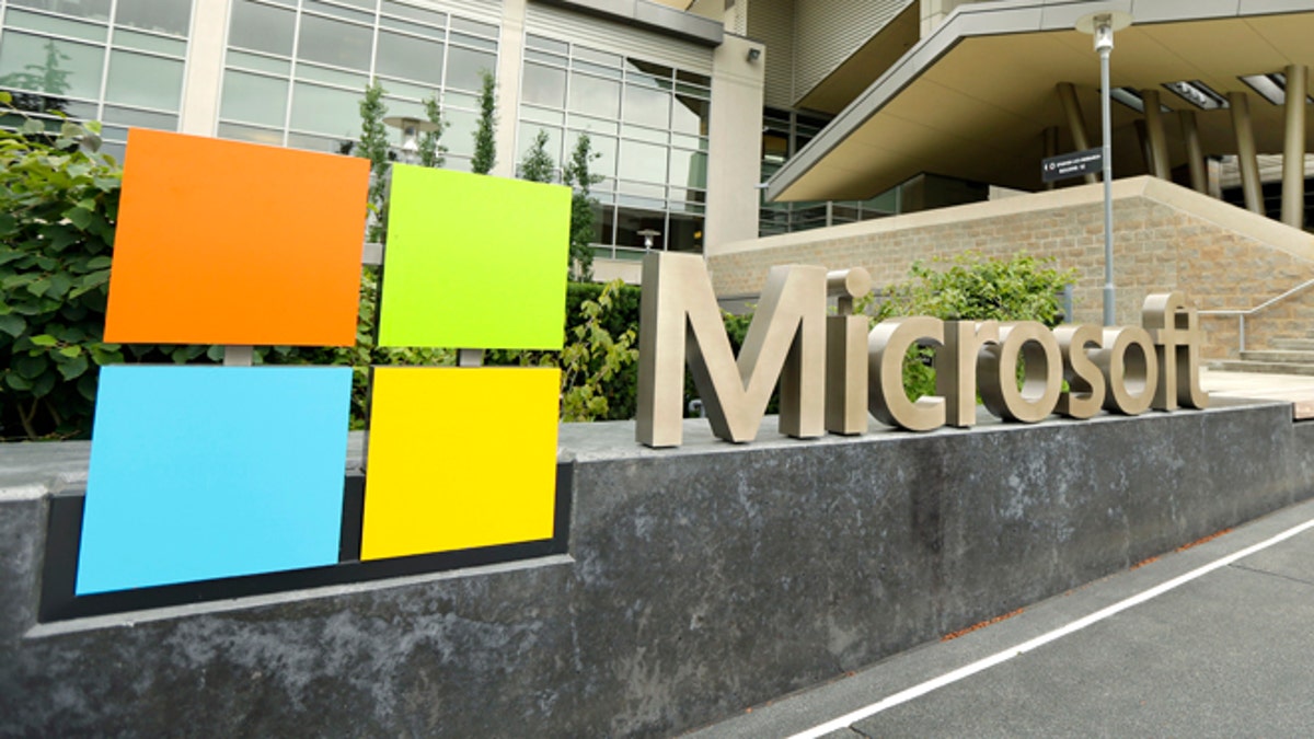 This July 3, 2014 photo shows Microsoft Corp. signage outside the Microsoft Visitor Center in Redmond, Wash. Microsoft on Thursday, July 17, 2014 announced it will lay off up to 18,000 workers over the next year. (AP Photo Ted S. Warren)