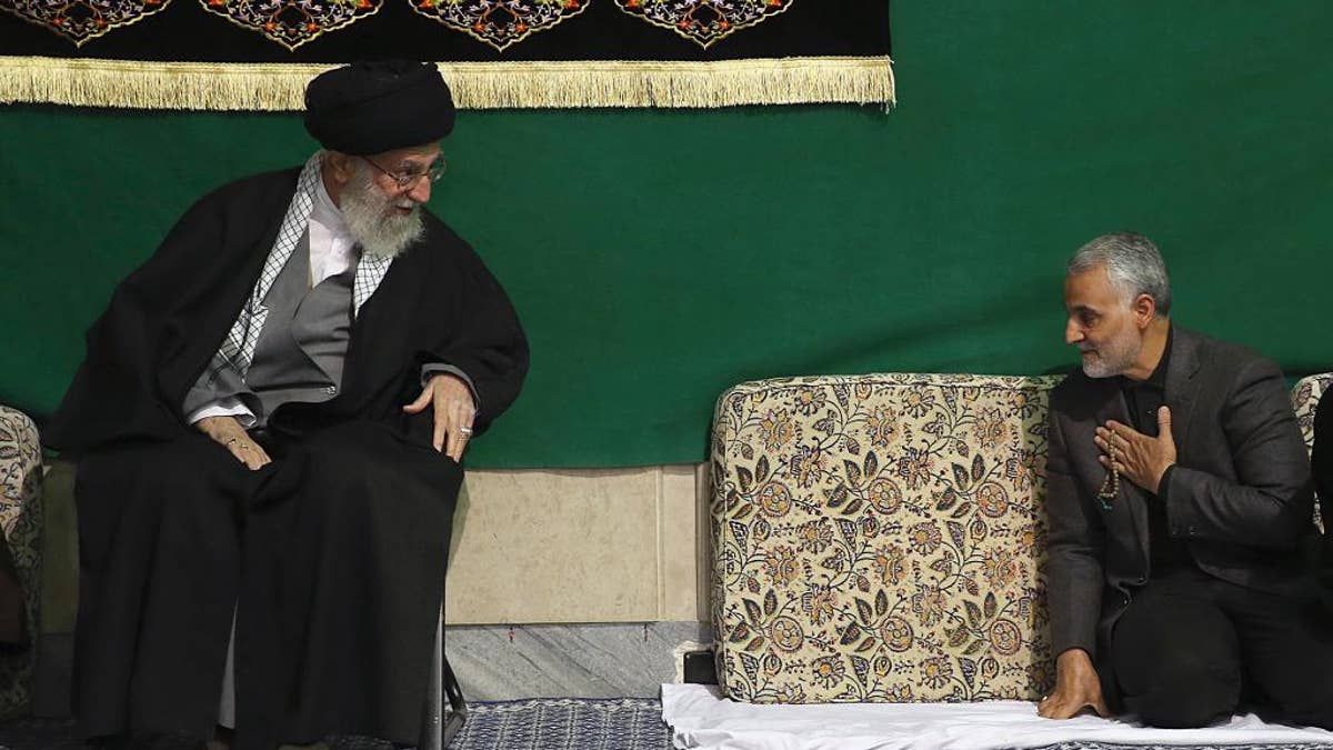 FILE - In this Friday, March 27, 2015 file photo released by the official website of the office of the Iranian supreme leader, commander of Iran's Quds Force, Qassem Soleimani, right, greets Supreme Leader Ayatollah Ali Khamenei while attending a religious ceremony in a mosque at his residence in Tehran, Iran. The chief of an elite unit in Iran's Revolutionary Guard has accused the U.S. of having 