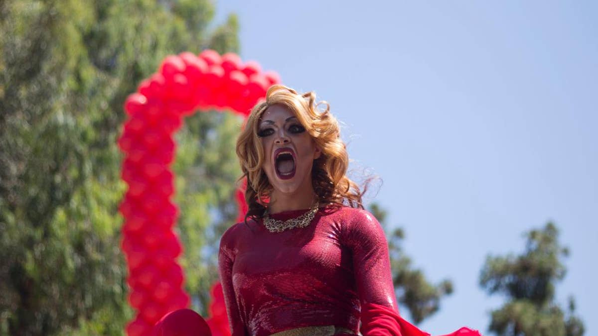 A drag queen sings during the annual Gay Pride Parade in Tel Aviv, Israel, Friday, June 12, 2015. Thousands of bare-chested muscular men, drag queens in heavy makeup and high heels, women in colorful balloon costumes and others partied at Tel Aviv's annual gay pride parade on Friday, the largest event of its kind in the region. (AP Photo/Ariel Schalit)