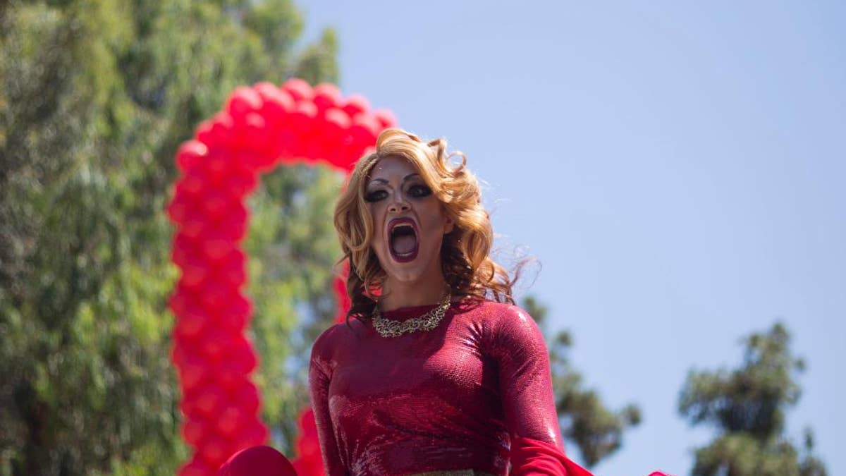 A drag queen sings during the annual Gay Pride Parade in Tel Aviv, Israel, Friday, June 12, 2015. Thousands of bare-chested muscular men, drag queens in heavy makeup and high heels, women in colorful balloon costumes and others partied at Tel Aviv's annual gay pride parade on Friday, the largest event of its kind in the region. (AP Photo/Ariel Schalit)