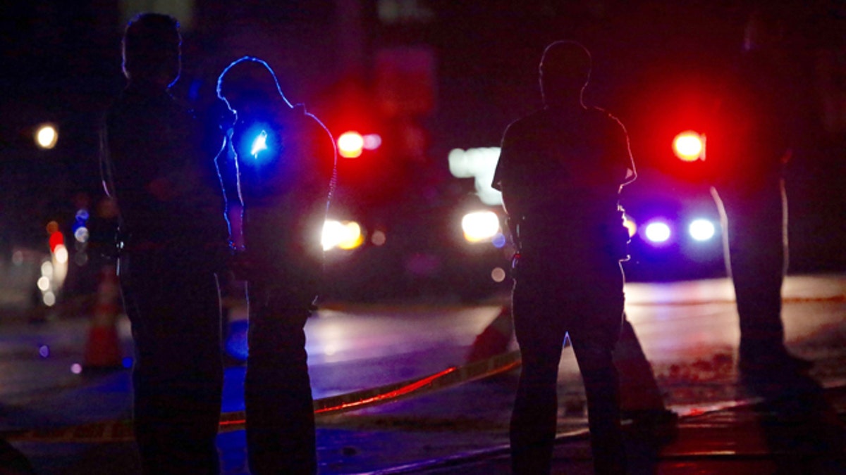 Investigators work at the scene of a police involved shooting with St. Anthony Police officers on Wednesday, July 6, 2016, in Falcon Heights, Minn. Police in Minnesota say a man has been taken to a hospital in unknown condition after being shot by an officer while inside a car with a woman and a child. St. Anthony Police interim police chief Jon Mangseth told reporters at a news conference that the incident began when an officer from his agency initiated a traffic stop around 9 p.m. Wednesday in Falcon Heights, a St. Paul suburb. (Leila Navidi/Star Tribune via AP)