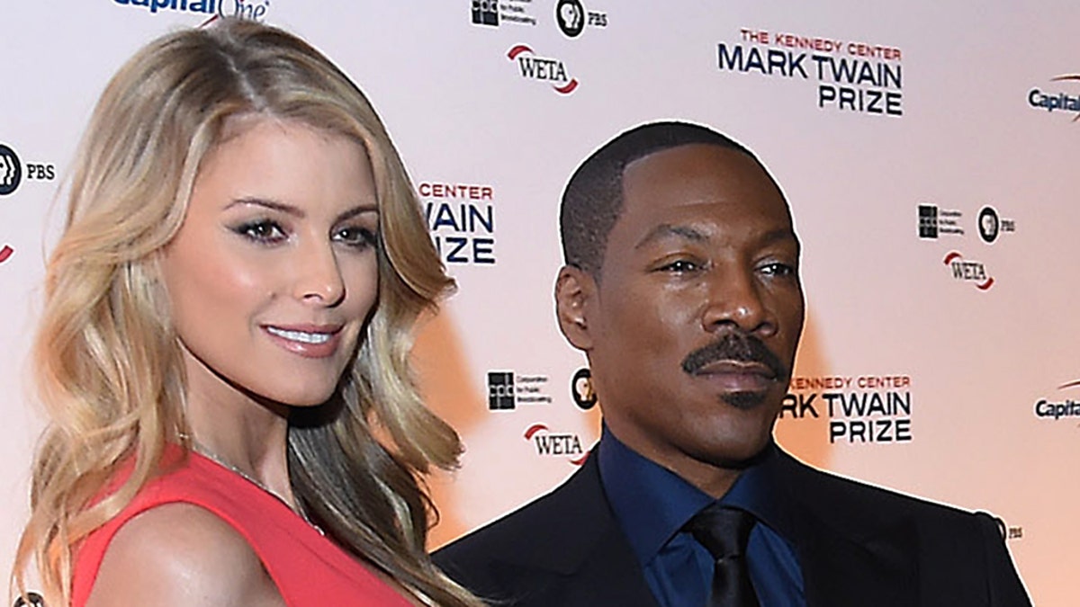 WASHINGTON, DC - OCTOBER 18: Paige Butcher, left, and Eddie Murphy, center, are seen on the red carpet at the Kennedy Center for the Mark Twain Prize for American Humor ceremony that honored Murphy on Sunday October 18, 2015 in Washington, DC. (Photo by Matt McClain/ The Washington Post via Getty Images)