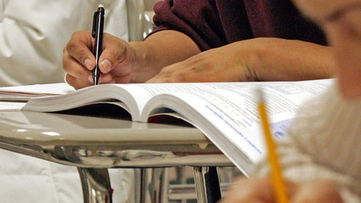 Students work out math problems during a class