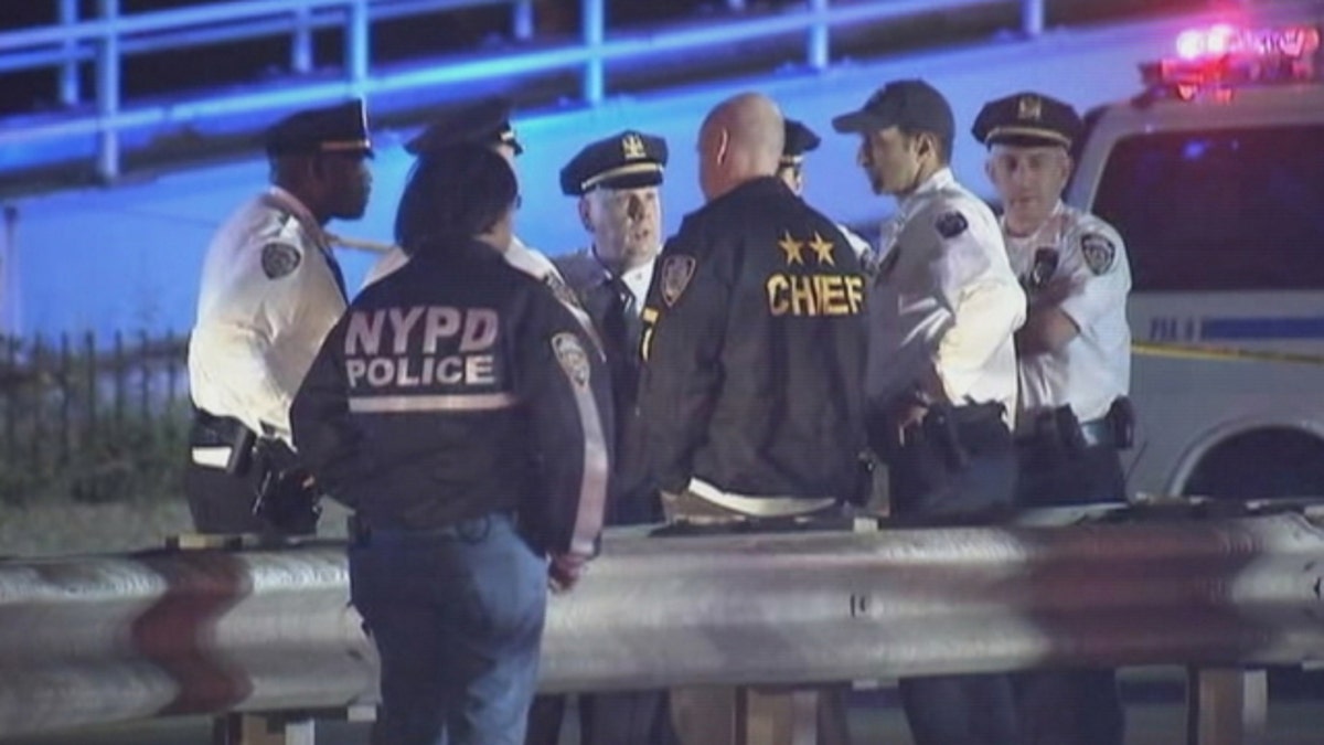 Oct. 20, 2015: Police officers gather near the site where a police officer was shot and critically wounded near the FDR Drive in East Harlem (WNYW)