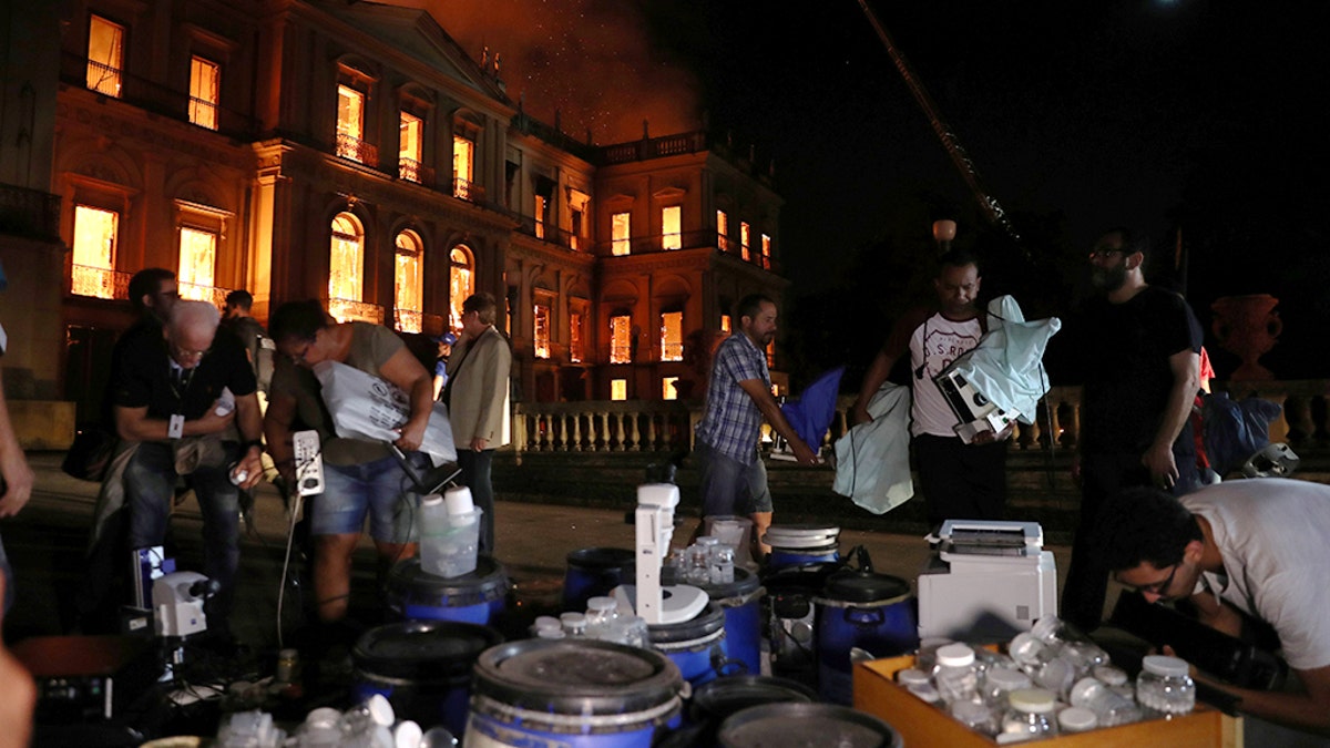 People rescue items during a fire at the National Museum of Brazil in Rio de Janeiro, Brazil September 2, 2018. REUTERS/Ricardo Moraes