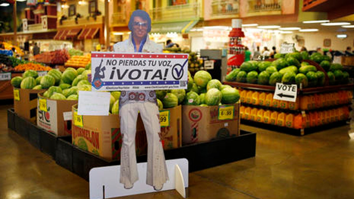 A sign in Spanish which translates, "Don't Lose Your Voice, Vote!" is displayed near a polling place in a Cardenas supermarket in Las Vegas on Friday, June 10, 2016. In the battleground state of Nevada, some 17 percent of eligible voters are Hispanics. Here, Latinos have clearly demonstrated the power they wield when they either turn out or stay home. In 2008 and 2012 they helped President Barack Obama; they were critical in re-electing Sen. Harry Reid in 2010. In the 2014 midterms, though, Hispanic turnout plummeted, and Republicans swept every statewide office and won control of both houses of the Legislature for the first time since 1929. (AP Photo/John Locher)