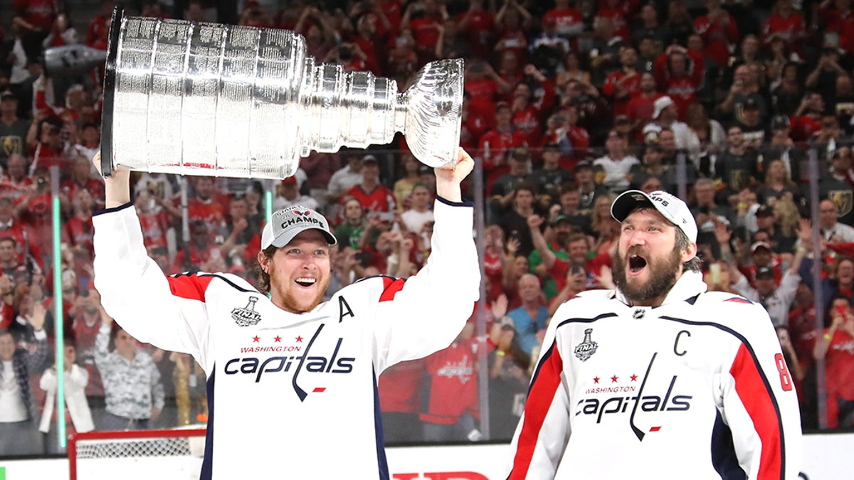 LAS VEGAS, NV - JUNE 07:  Alex Ovechkin #8 hands of the Stanley Cup to Nicklas Backstrom #19 of the Washington Capitals after their team's 4-3 win over the the Vegas Golden Knights in Game Five of the 2018 NHL Stanley Cup Final at T-Mobile Arena on June 7, 2018 in Las Vegas, Nevada.  (Photo by Bruce Bennett/Getty Images)