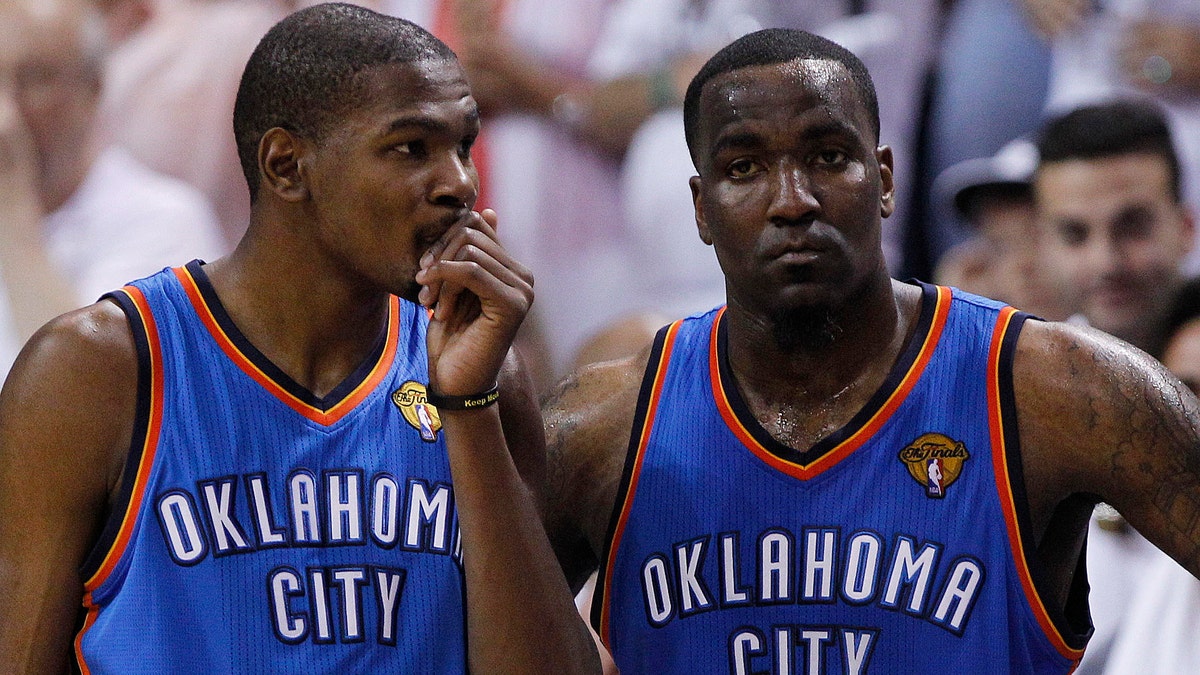 Oklahoma City Thunder small forward Kevin Durant (35) and center Kendrick Perkins (5) react against the Miami Heat during the second half at Game 3 of the NBA Finals basketball series, Sunday, June 17, 2012, in Miami. Miami won 91-85. (AP Photo/Lynne Sladky)